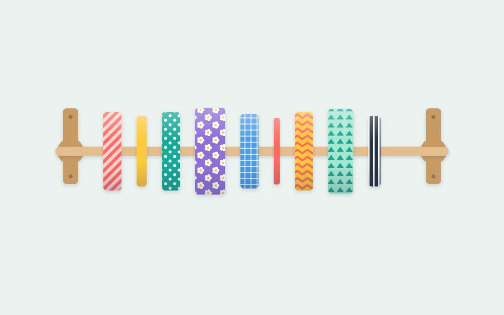 Row of washi tape rolls threaded on a horizontal wooden dowel held by two small brackets