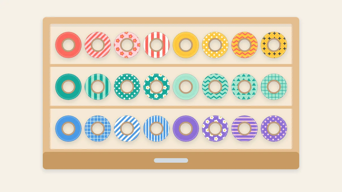 Shallow open drawer with rows of washi tape rolls sorted by color between dividers