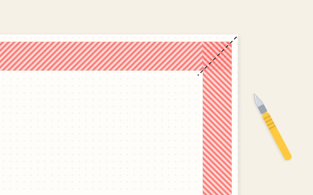 Page corner where two tape strips overlap, with a diagonal cut line and a craft knife