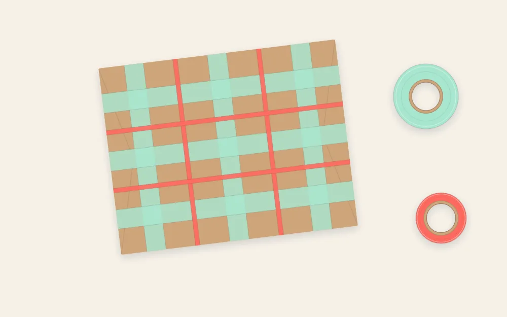 Wrapped gift covered with a plaid pattern of thin and wide tape strips crossing at right angles