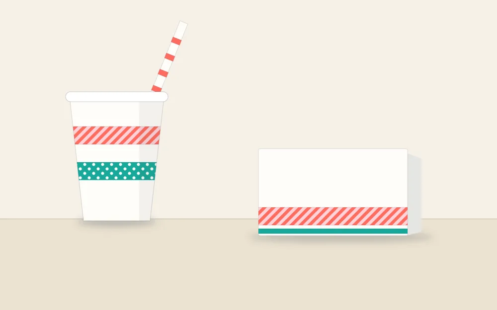 A paper cup with two washi tape bands, a striped place card and a banded straw
